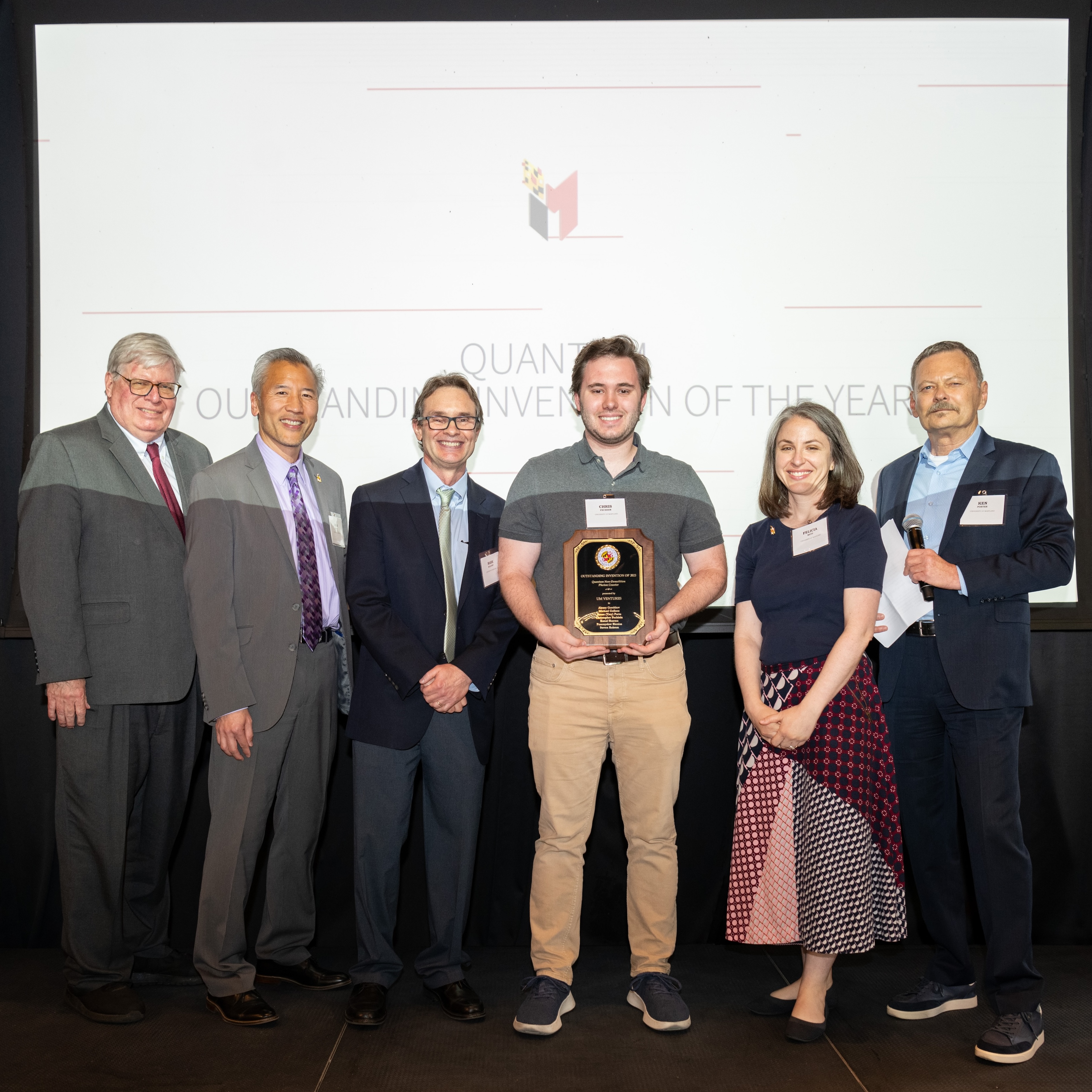 Chris Fechisin accepting award on stage.