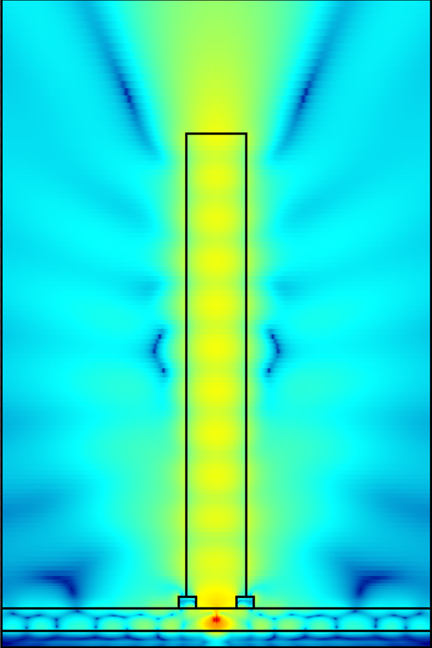 A black rectangle stands on a base. Around the rectangle is various shades of blue but inside the rectangle is an irregular yellow and green pattern that then spreads into the blue from the top of the tower.